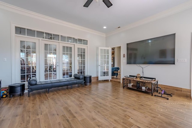 living room with crown molding, french doors, ceiling fan, and light hardwood / wood-style flooring