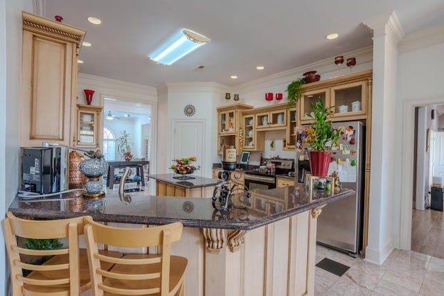 kitchen featuring kitchen peninsula, a breakfast bar, ornamental molding, and appliances with stainless steel finishes