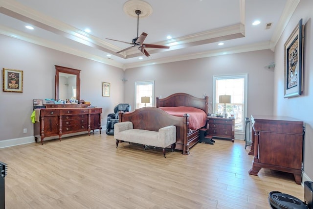 bedroom with a tray ceiling, ceiling fan, light hardwood / wood-style floors, and ornamental molding