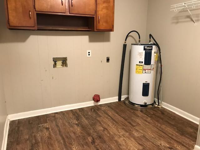 laundry room with cabinets, washer hookup, electric dryer hookup, electric water heater, and dark hardwood / wood-style floors