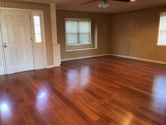 entryway featuring ceiling fan, dark hardwood / wood-style flooring, and ornamental molding