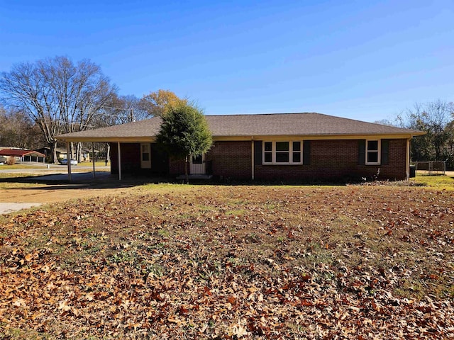 ranch-style home featuring a carport