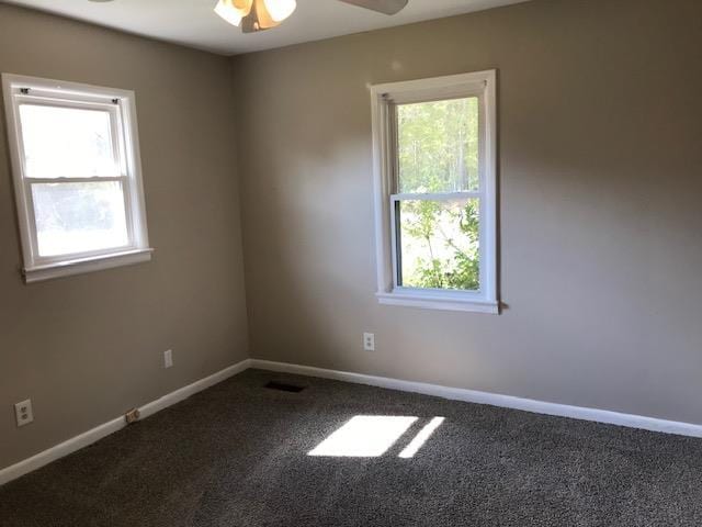 carpeted empty room featuring ceiling fan