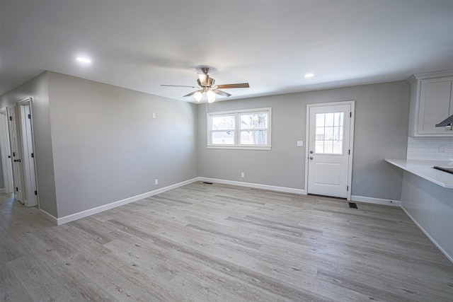 interior space with ceiling fan and light hardwood / wood-style floors