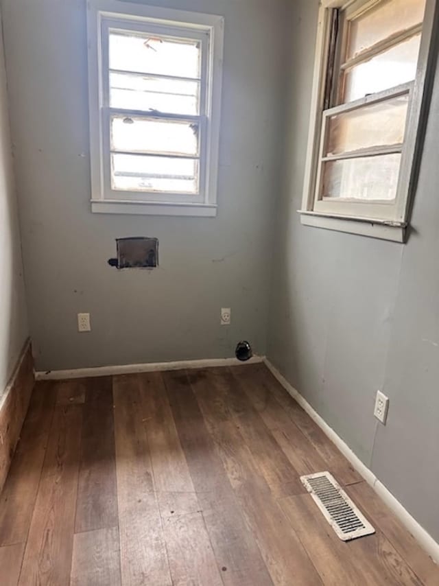 empty room with hardwood / wood-style floors and visible vents