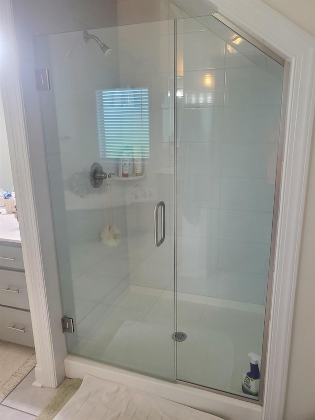 bathroom with tile patterned flooring and a shower with door