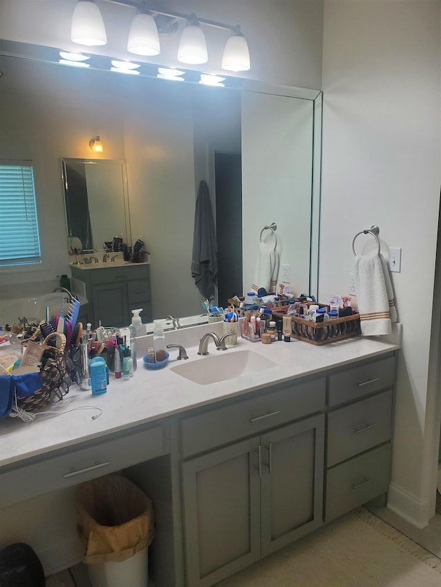 bathroom featuring tile patterned floors, a tub to relax in, and vanity