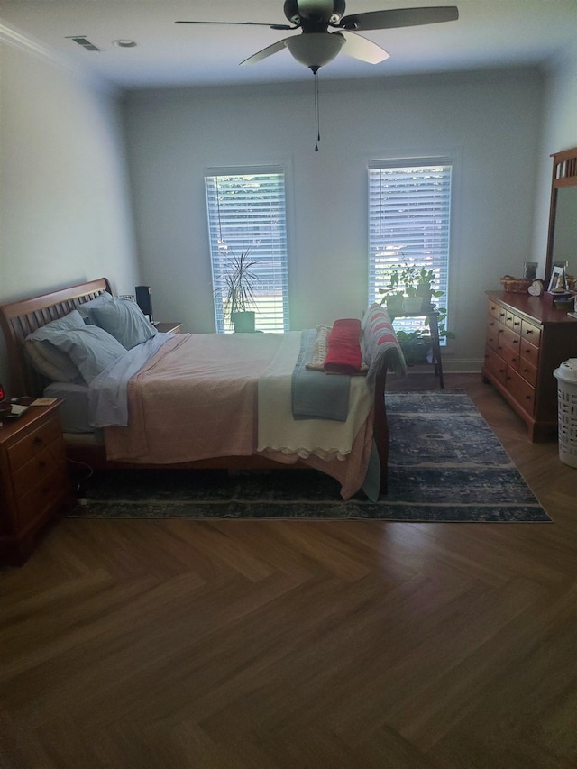 bedroom featuring ceiling fan and dark parquet flooring