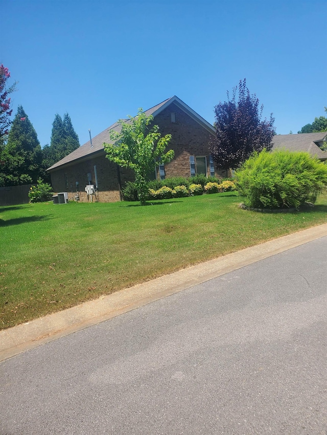 view of side of home featuring a lawn