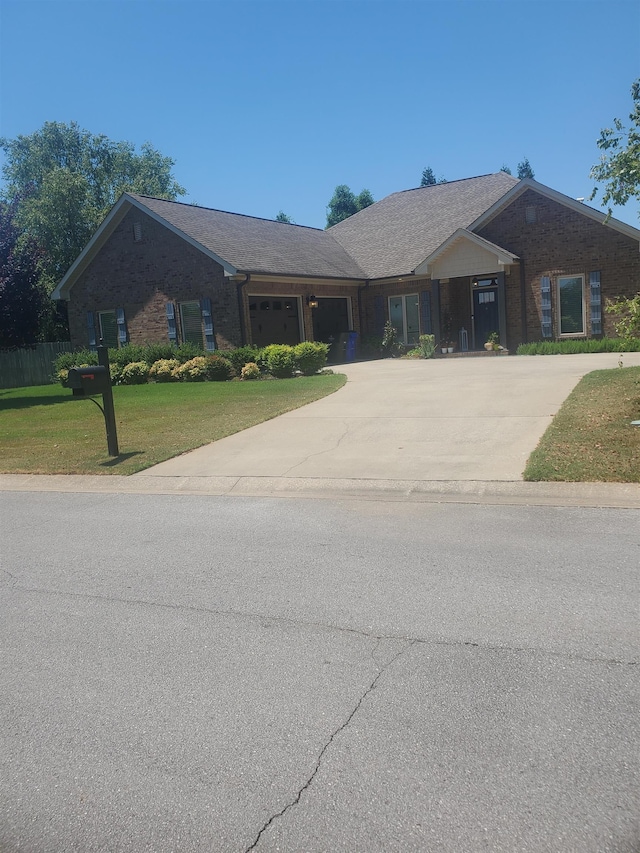 ranch-style home with a front yard and a garage