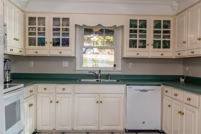 kitchen featuring white cabinetry, a sink, dark countertops, and white appliances