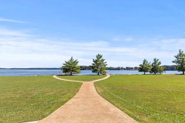  - view of property's community with a water view and a yard