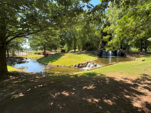  - view of grassy yard with a water view
