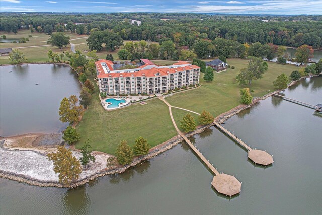  - aerial view of a nearby body of water and a pool area