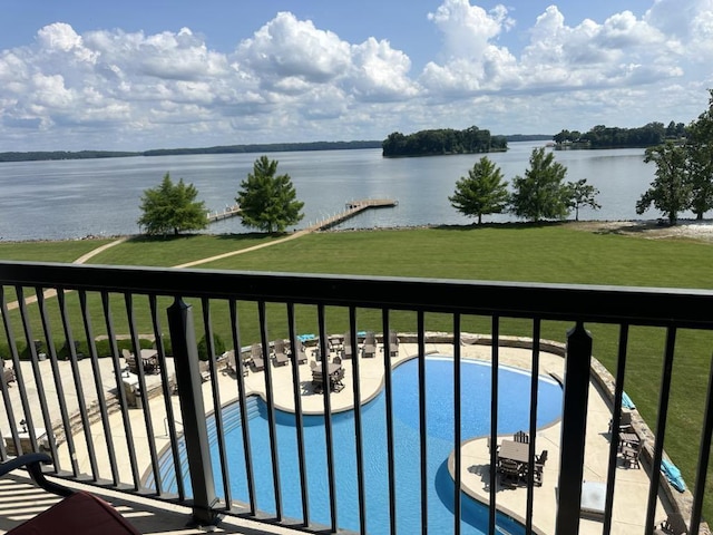  - balcony featuring a water view and view of pool