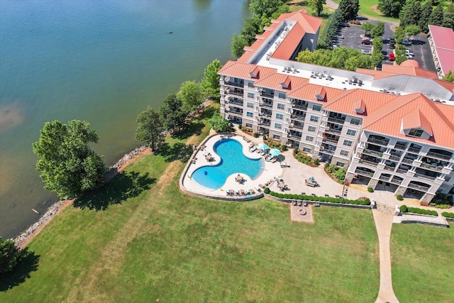  - bird's eye view of a pool area and a nearby body of water