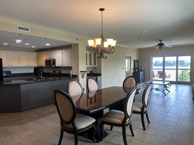  - dining area featuring ornamental molding, a chandelier, a textured ceiling, a ceiling fan, and light tile patterned floors