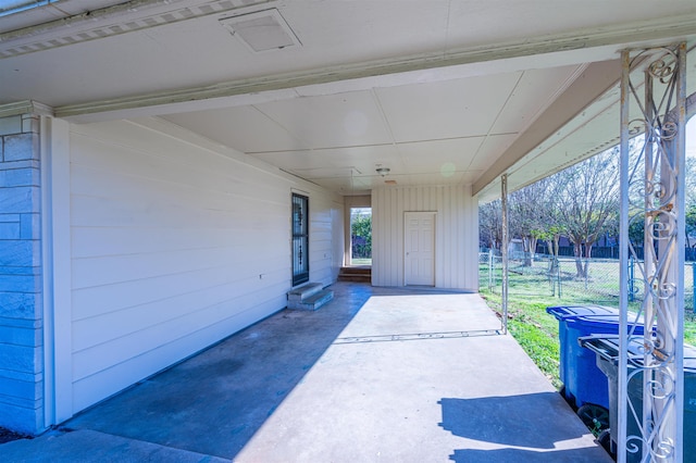 view of patio / terrace featuring fence and a carport