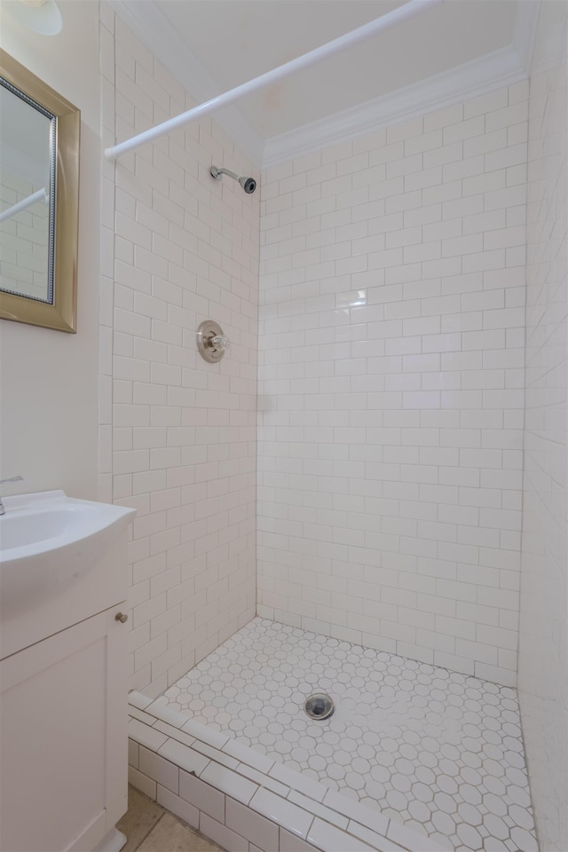 bathroom featuring crown molding, vanity, and a stall shower