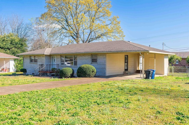ranch-style home with a front lawn, driveway, a shingled roof, an attached carport, and fence