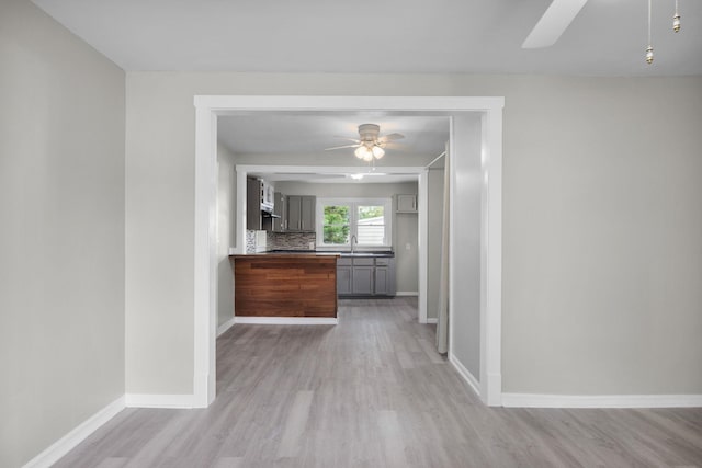 corridor featuring light hardwood / wood-style flooring and sink