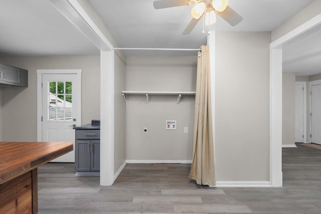 clothes washing area with hookup for an electric dryer, washer hookup, light hardwood / wood-style flooring, and ceiling fan