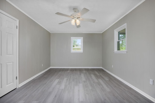 spare room with ceiling fan, ornamental molding, and light hardwood / wood-style flooring