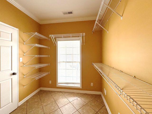 spacious closet featuring light tile patterned flooring and visible vents