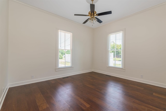  - empty room with healthy amount of natural light, dark wood finished floors, baseboards, crown molding, and ceiling fan