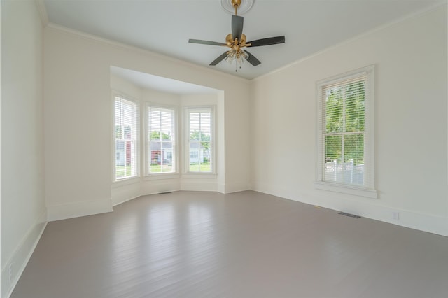  - unfurnished room with wood finished floors, ornamental molding, a ceiling fan, and baseboards