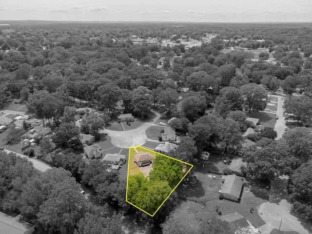 birds eye view of property with a view of trees