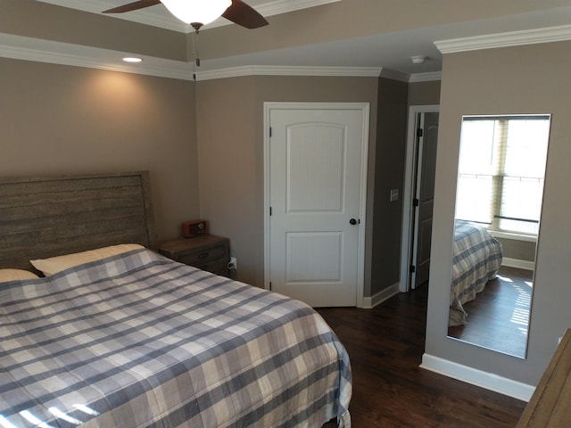 bedroom with ornamental molding, dark wood-type flooring, and ceiling fan