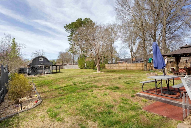  - view of yard featuring a fenced backyard, a gazebo, and an outdoor structure