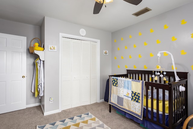  - bedroom featuring a closet, a nursery area, baseboards, visible vents, and carpet