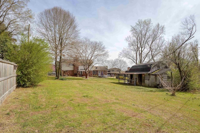  - view of yard featuring fence and a barn