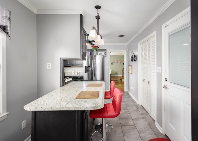  - kitchen with tile patterned flooring, stainless steel refrigerator with ice dispenser, ornamental molding, backsplash, and visible vents