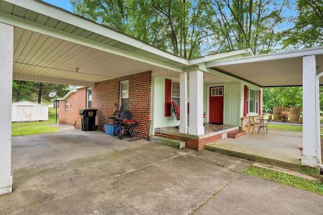  - covered porch with a shed and a carport
