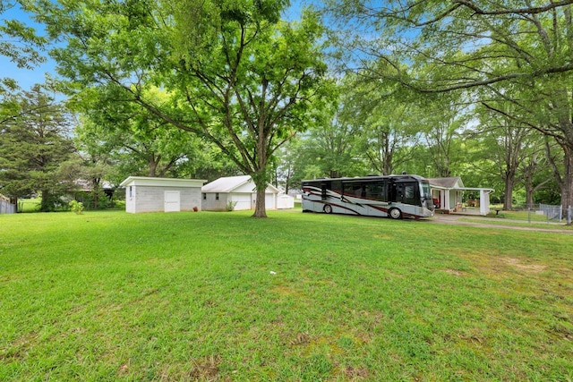  - view of yard featuring an outdoor structure and view of wooded area