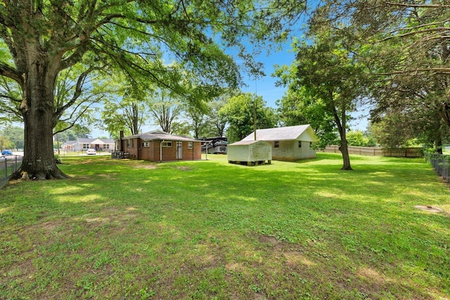  - fenced backyard featuring an outbuilding