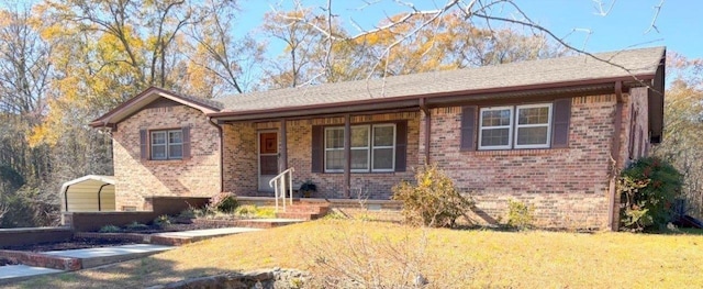 ranch-style home featuring a front yard and a carport