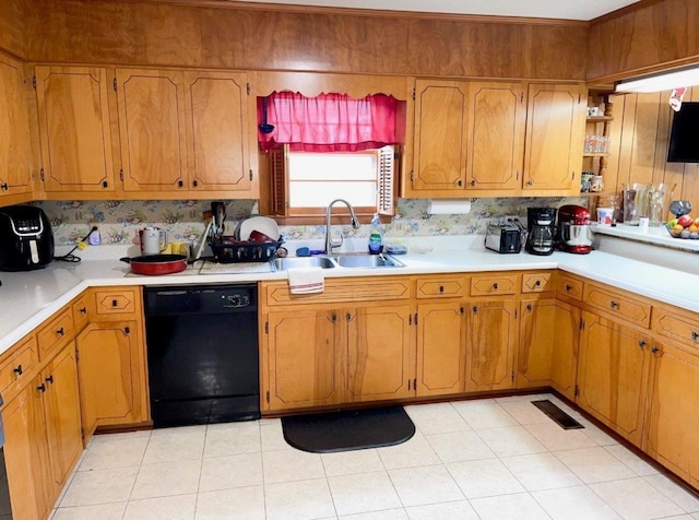 kitchen featuring light tile patterned flooring, black dishwasher, and sink