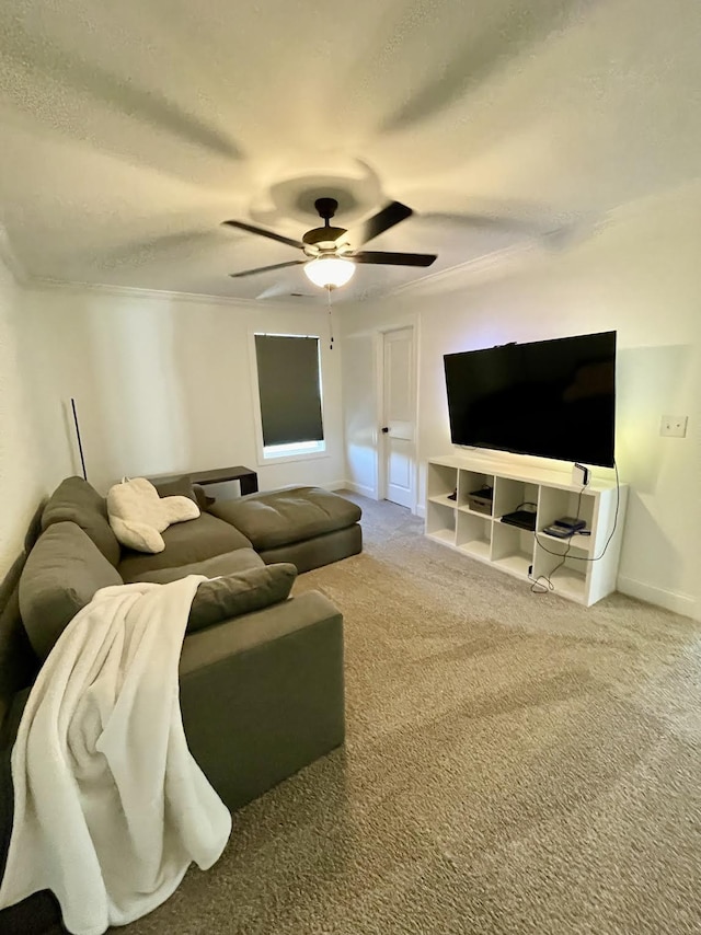 living room with carpet flooring, ceiling fan, and crown molding