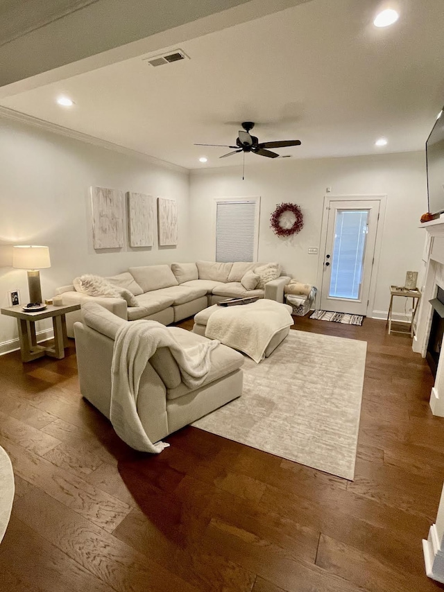 living room featuring ceiling fan and dark wood-type flooring