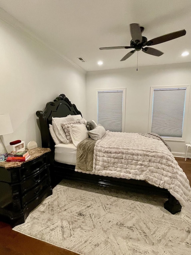 bedroom with ceiling fan, dark hardwood / wood-style floors, and crown molding