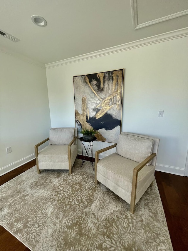 sitting room with crown molding and hardwood / wood-style floors