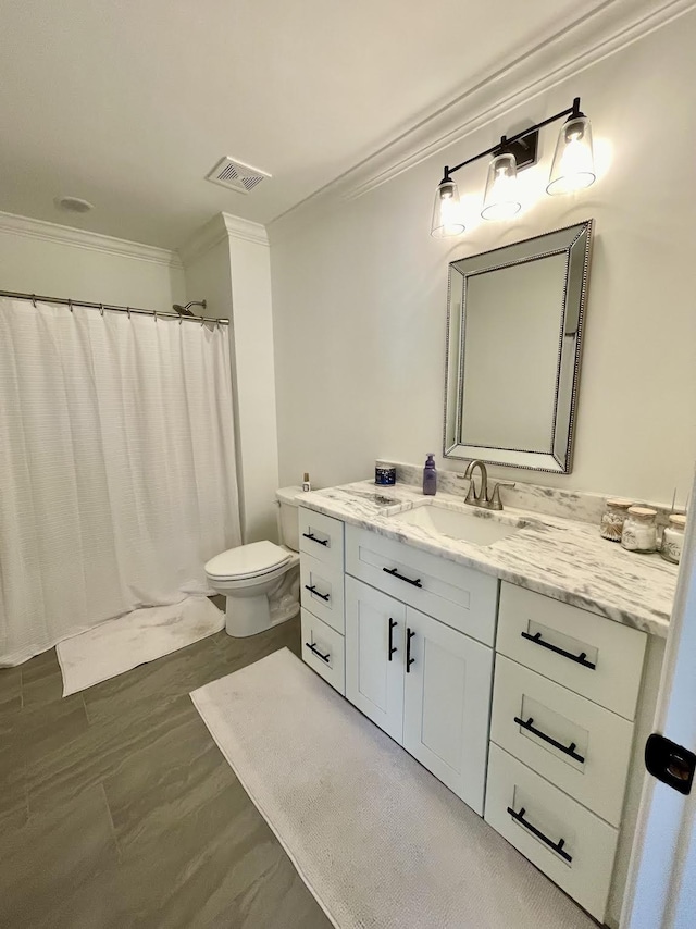 bathroom featuring vanity, toilet, walk in shower, and ornamental molding