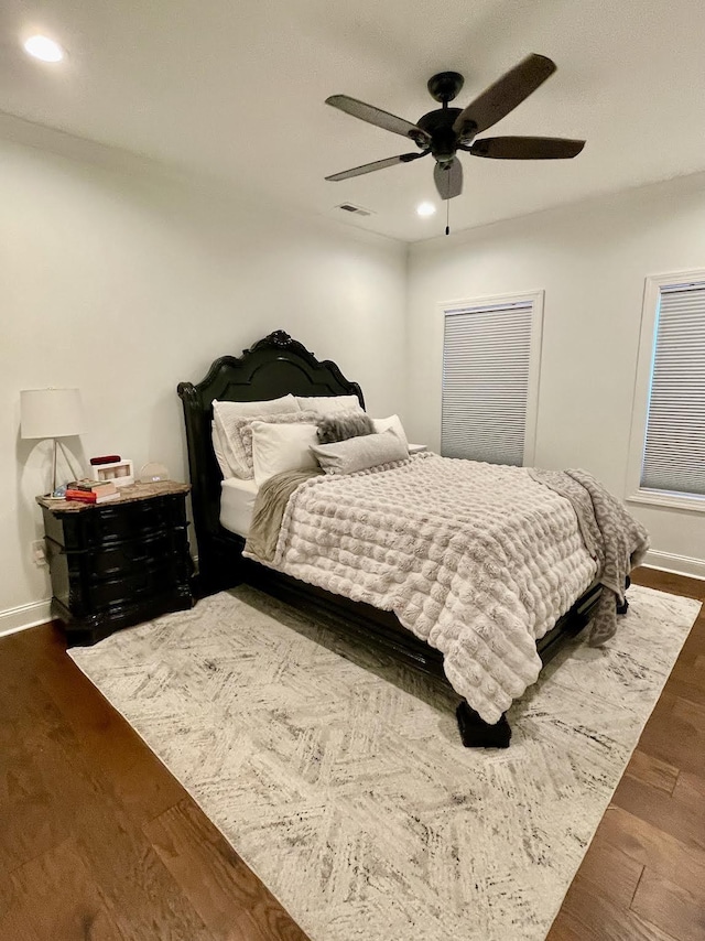 bedroom featuring dark hardwood / wood-style floors and ceiling fan