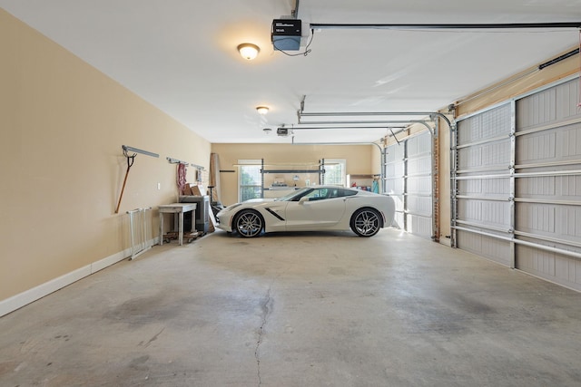 garage featuring baseboards and a garage door opener