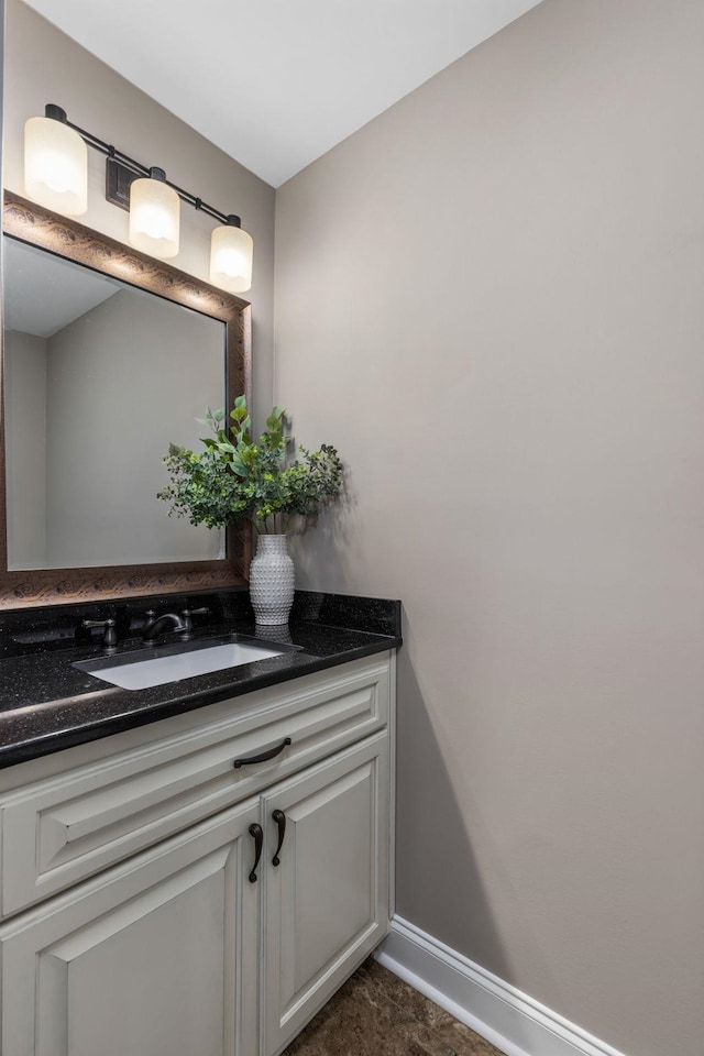 bathroom featuring baseboards and vanity