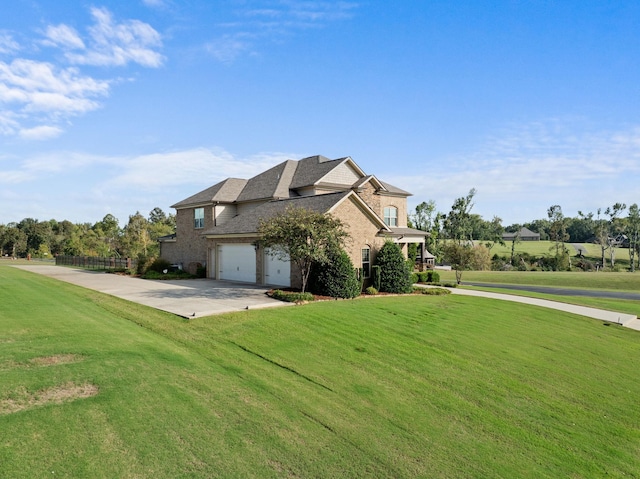 view of home's exterior featuring concrete driveway, a lawn, fence, and brick siding